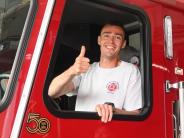 Thumbs up for a job well done, fireman gives a thumbs up after parking the truck